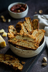 Homemade savory biscotti with dried tomatoes, pistachios, parmesan and aromatic herbs.