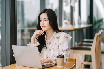 Portrait of smiling beautiful business asian woman working in modern office desk using tablet laptop computer, Business people employee freelance online marketing e-commerce telemarketing concept.