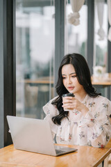 Fototapeta premium Portrait of smiling beautiful business asian woman working in modern office desk using tablet laptop computer, Business people employee freelance online marketing e-commerce telemarketing concept.