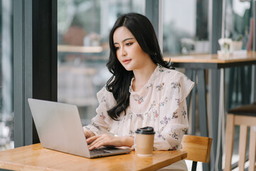 Startup successful small business owner sme beauty girl stand with tablet smartphone in coffee shop restaurant. Portrait of asian tan woman barista cafe owner. SME entrepreneur seller business concept