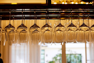 Blank wine glasses background hang on the shelf of counter bar