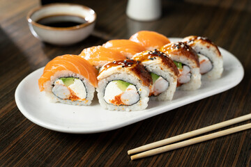 Sushi Roll with salmon, eel, tuna, avocado, royal prawn, cream cheese, caviar tobiko, chuka. Sushi menu. Japanese food.
