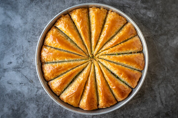 Carrot slice baklava with pistachio. Tray baklava on dark background. Traditional Turkish cuisine delicacies. close up