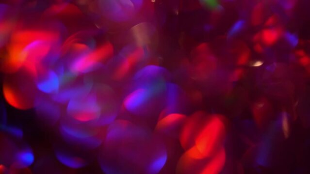 Purple red bokeh motion. Festive purple, blue and red luminous colorful lights bokeh movement background. Purple bokeh lights abstract moving background.