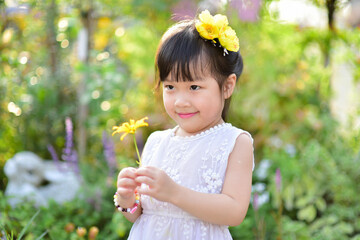 backlight Outdoor portrait of a cute 5 year old Asia little girl 