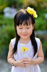 backlight Outdoor portrait of a cute 5 year old Asia little girl 