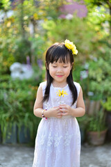 backlight Outdoor portrait of a cute 5 year old Asia little girl 