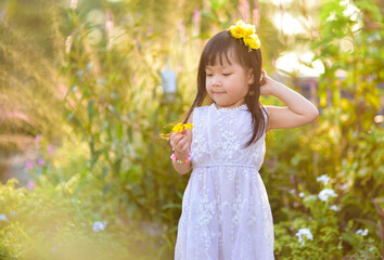 backlight Outdoor portrait of a cute 5 year old Asia little girl 