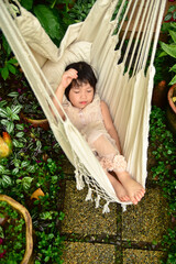 cute little Girl sleeping in hammock chair