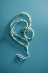 Islam prayer beads against blue background