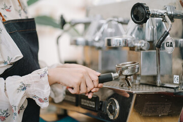 Opening a small business, AHappy Asian woman in an apron standing near a bar counter coffee shop, Small business owner, restaurant, barista, cafe, Online, SME, entrepreneur, and seller concept