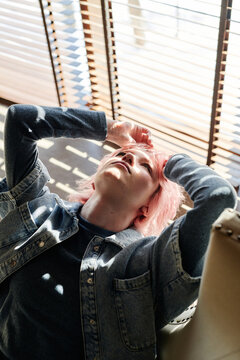 High angle view of difficult teenage girl with pink hair worrying about her problem