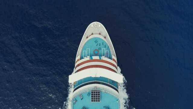 Cruise ship large commercial passenger liner sailing in ocean aerial top view