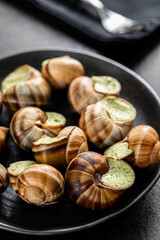 Snails with parsley butter, Bourgogne Escargot Snails on plate. Delikatese food.