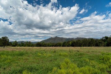 Naklejka na ściany i meble Rural landscape with blue sky and clouds over the mountain. Widgee, Queensland, Australia 