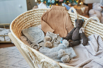 Obraz premium Baby knitted clothes and accessories. Baby shower party. Christening dress. Handmade knitting. Christmas background
