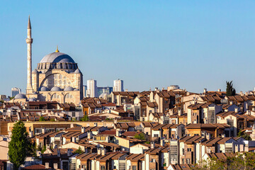 Fototapeta na wymiar Mihrimah Sultan mosque and panoramic view of the skyline and houses roofs at Fatih. Istanbul, Turkey, public space. Urban life and architecture concept