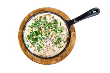 Mussels in creamy sauce with parsley in hot frying pan on wooden stand. Tasty meal in sea restaurant attracts tourist attention to explore