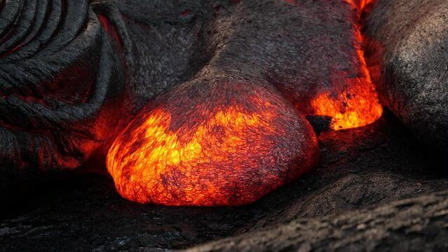A river of red-hot lava from an exploding volcano