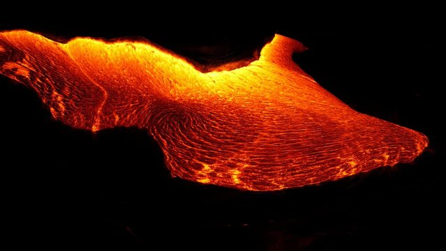 A river of red-hot lava from an exploding volcano