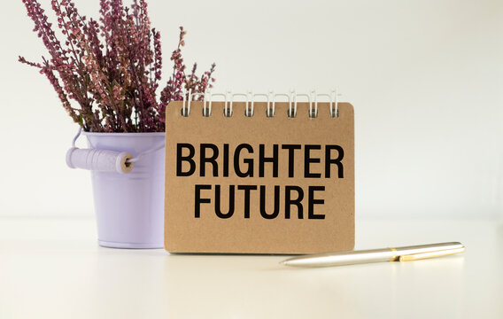 Brighter Future Text On Notepad On Office Desk. Business Concept