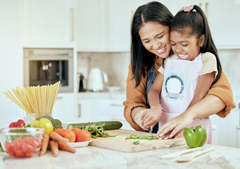 Happy, mother and child learning to cook with smile for help, guidance and support in the kitchen....