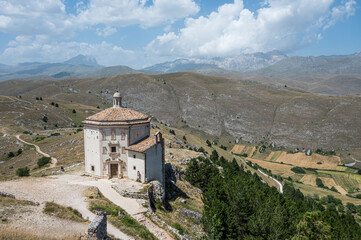 The church of Santa Maria della Pietà in Rocca Calascio with the beautiful Abruzzo mountains and hills in the background