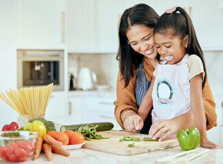Cooking, health and mother and girl in kitchen for food, learning and salad together. Help, support...