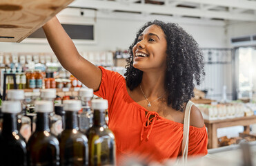 Supermarket, shelf and shopping customer woman retail store for eco friendly product, olive oil or groceries choice. Happy woman in small business store marketplace with choice or food sale discount - Powered by Adobe