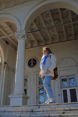 A young tourist on the stairs of an old estate.