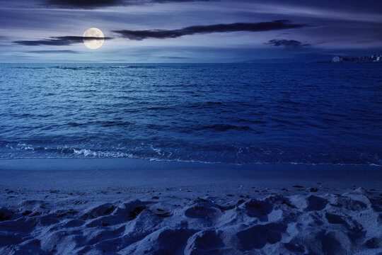 minimalistic seascape in summer at night. beach sea and horizon in full moon light. purity in nature