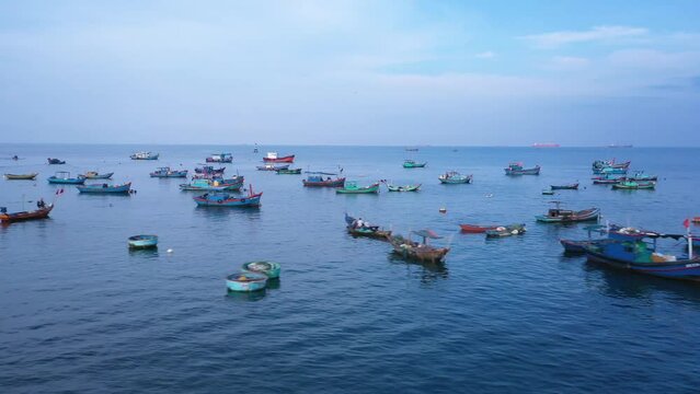 Fishing boats anchored at the marina in Vung Tau iin early morning light. A long aerial tracking shot showing many different types of boats.