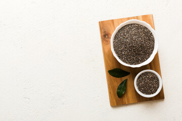Chia seeds in bowl on colored background. Healthy Salvia hispanica in small bowl. Healthy superfood