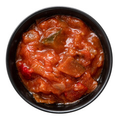 Ratatouille in black ceramic bowl isolated from above.