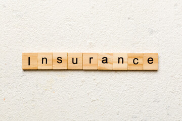 insurance word written on wood block. insurance text on table, concept