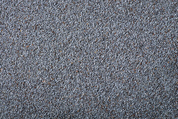 Background of dark poppy seed. Top down shot of poppy seed on the table