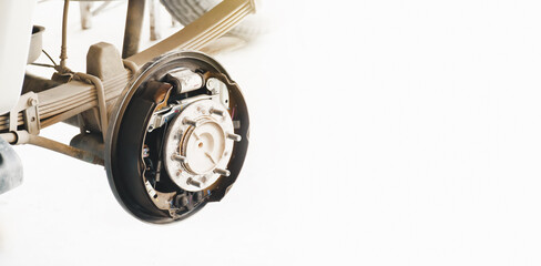 Inside system of the car drum brake, car without a wheel for brake inspection in the auto repair garage , panoramic banner with copy space on white background © BLKstudio