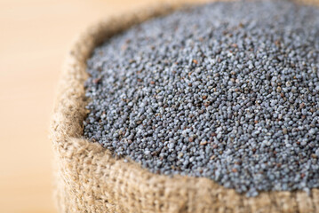 Poppy seed in linen sack. Harvest of poppy plant, storage of poppy seed