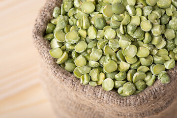 Linen sack with green pea. Small fancy linen bag with dry green pea seed