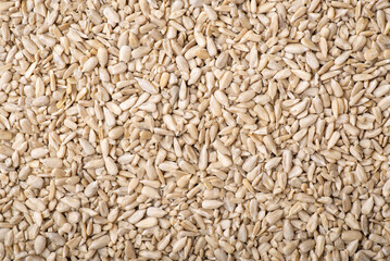 Top view background of peeled sunflower seeds. Harvested and peeled sunflower seeds