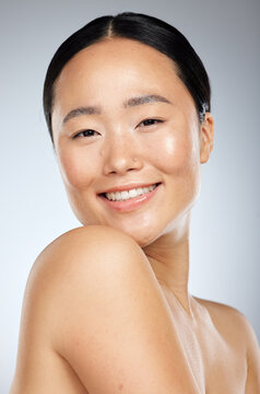 Beauty, asian and skincare with portrait of woman and smile for spa, cosmetics and clean wellness. Happy, makeup and facial treatment with girl for luxury, health and model in gray background studio