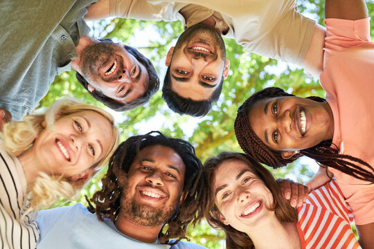 Various friends form a circle in the team building workshop