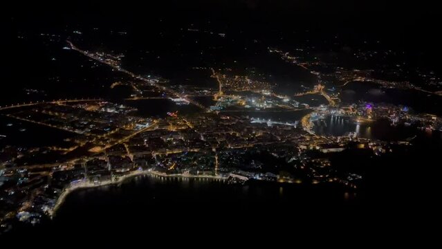 Aerial night view of Ibiza city, Spain, recorded from a jet cockpit during departure.