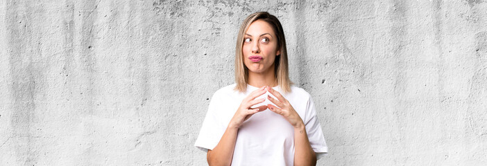 blonde adult woman scheming and conspiring, thinking devious tricks and cheats, cunning and...