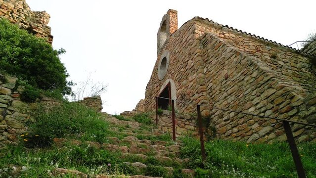 Ruined castle in Europe aerial footage cinematic medieval era  Low angle shot of a small church hermitage