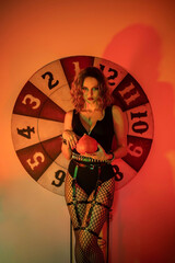 Circus sexy girl with a pumpkin in her hands. halloween costume