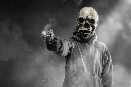 Man with a skull head costume holding gun