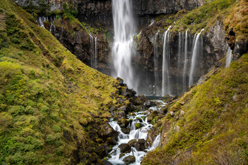 Obraz premium Colorful majestic waterfall in national park forest during autumn nature Photography.Landscape view national nature park Nikko Japan. Beautiful place