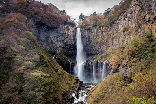 Colorful majestic waterfall in national park forest during autumn nature Photography.Landscape view national nature park Nikko Japan. Beautiful place © Dinusha