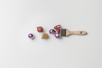 creative christmas concept with brush and decorative balls flat lay